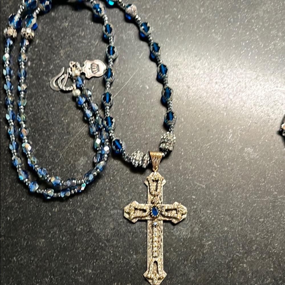 Long necklace with silver cz encrusted cross. Graduated blue glass beads